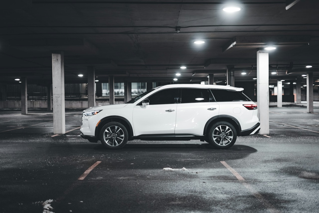 Representative white SUV photographed in an indoor parking garage.